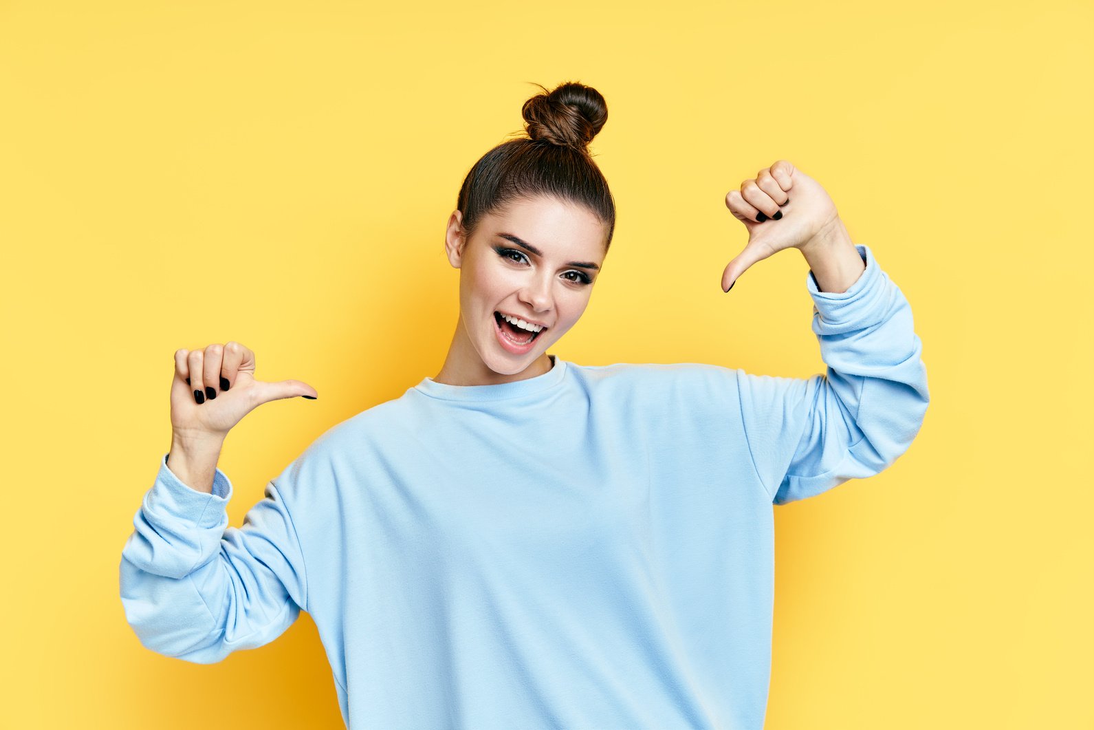 Young Happy Woman Pointing to Herself over Yellow Background